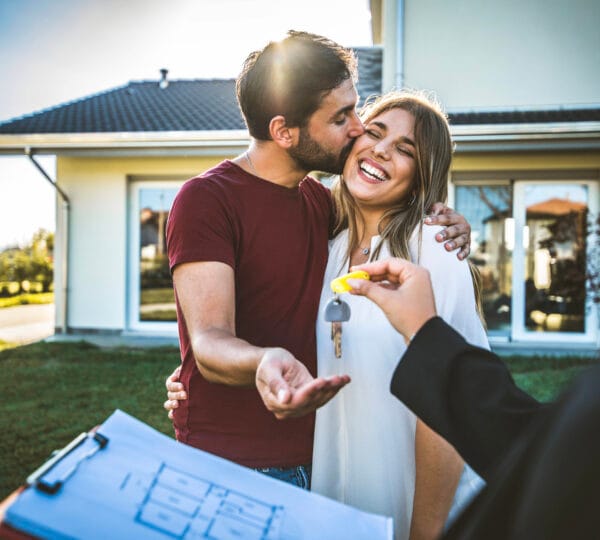 Happy couple holding the keys to their new Fort Wayne home
